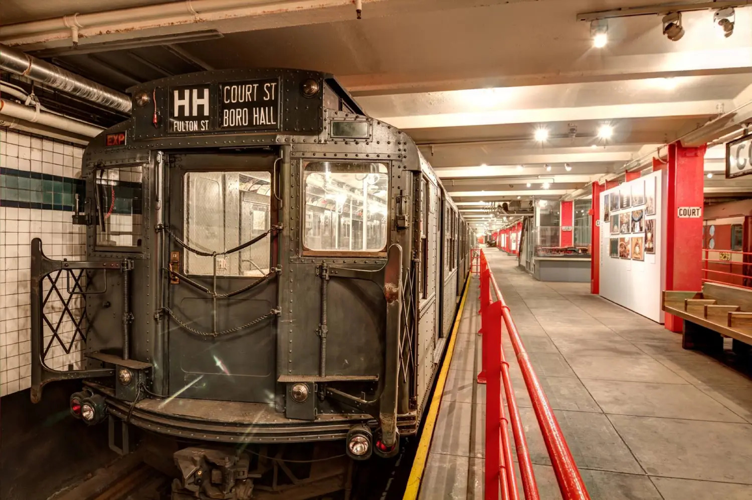 A vintage HH shuttle subway train sits in the station at the New York Transit Museum