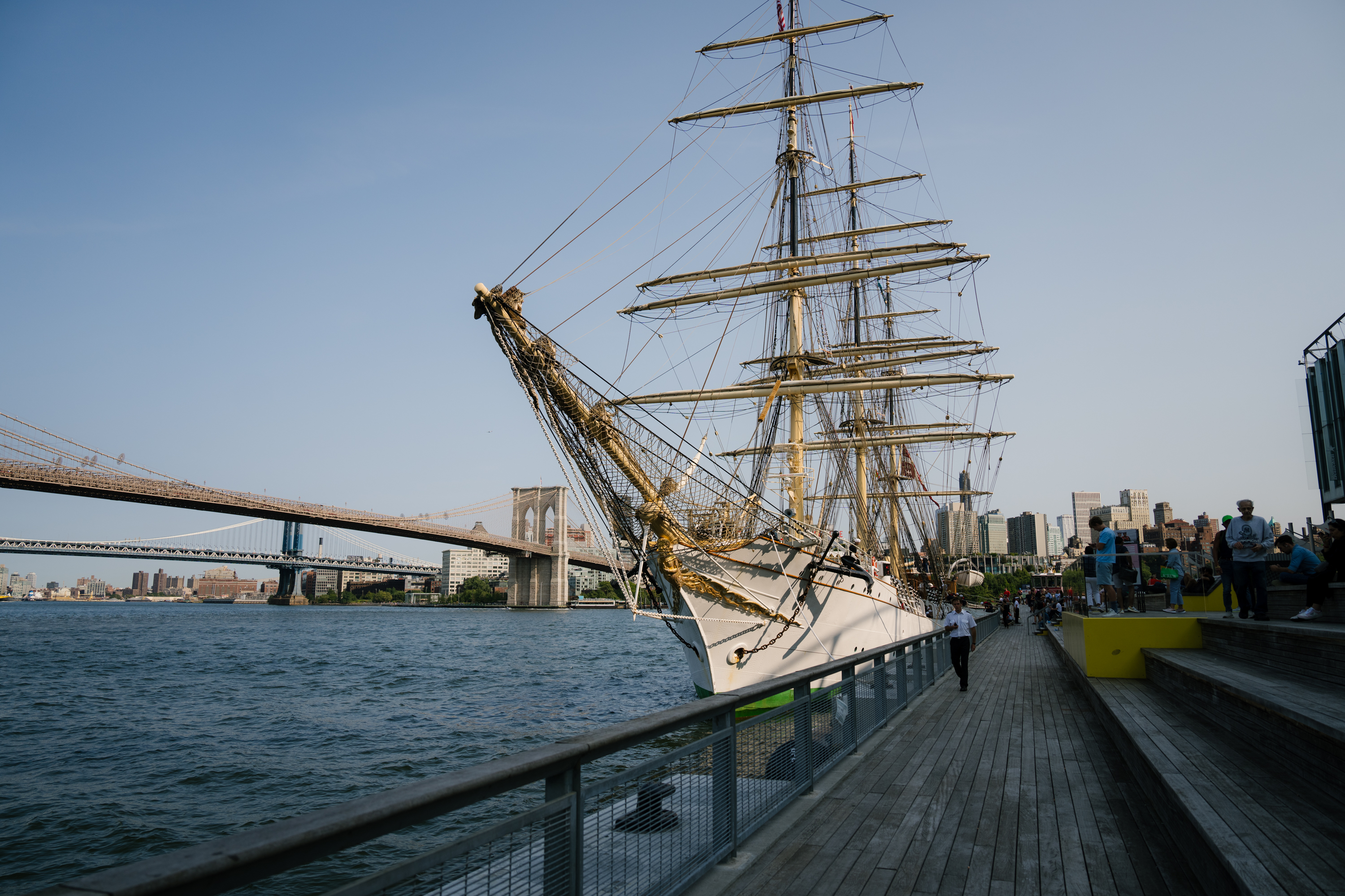 a tall ship docked at the seaport